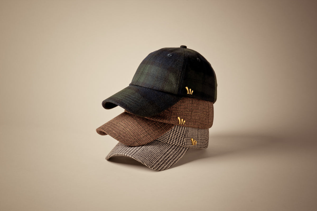 Stack of CHORD wool baseball caps in Blackwatch Tartan, Chatsworth Glen Plaid and Windsor Glen Plaid with gold-plated hardware