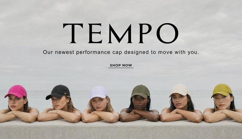 Promotional banner for TEMPO performance cap. The top half shows five models wearing different colored caps (pink, black, white, green, beige, yellow) leaning on a wall against a cloudy sky.